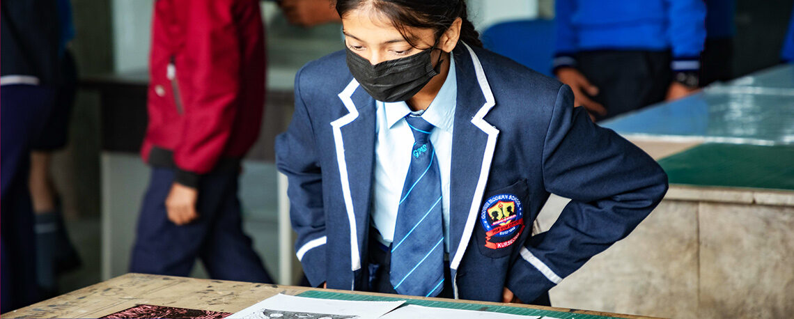 Girl student looking at a book on the table