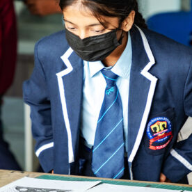 Girl student looking at a book on the table